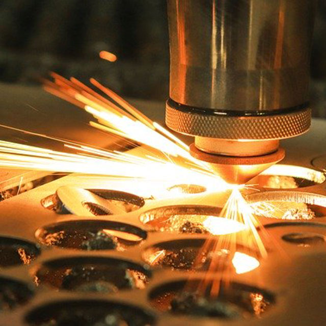 Image of a laser cutter cutting a piece of metal